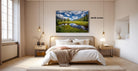 a serene bedroom with a large bed, wooden furniture, and a painting of a scenic landscape hanging on the wall.