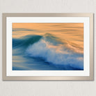 The image is a framed photograph of a beautiful ocean scene with a large, crashing wave in the foreground.