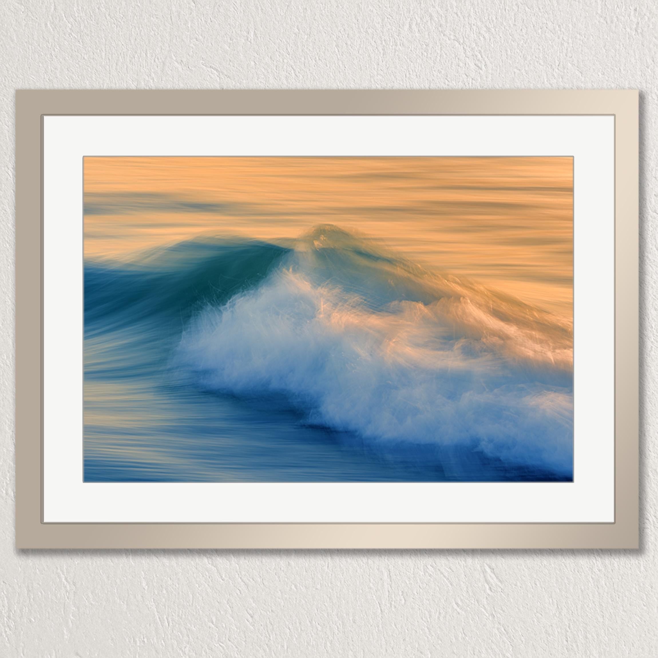 The image is a framed photograph of a beautiful ocean scene with a large, crashing wave in the foreground.