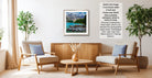 a modern living room with a wooden coffee table, two beige armchairs, and a framed landscape photograph hanging on the wall.