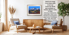 a living room with a framed landscape painting hanging on the wall, a wooden coffee table in the center, and two chairs facing each other.