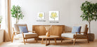 a cozy living room with two beige armchairs, a wooden coffee table, and a wooden sideboard. The room is decorated with potted plants and a vase of flowers, creating a warm and inviting atmosphere.