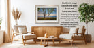a cozy living room with a wooden coffee table, two beige armchairs, and a framed landscape photograph hanging on the wall.