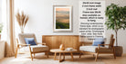 a living room with a framed landscape photograph hanging on the wall, a wooden coffee table in the center, and two armchairs facing each other.