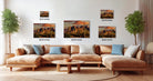 a living room with a large sectional sofa, a coffee table, and several framed landscape photographs displayed on the wall.