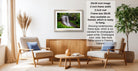 a living room with a framed photograph of a waterfall hanging on the wall. The room has two armchairs, a coffee table, and a potted plant. The photograph is framed in a modern style, and the frame size is 28.38 inches wide. The text indicates that the frame is available in both framed and unframed versions, and it is ready to hang.