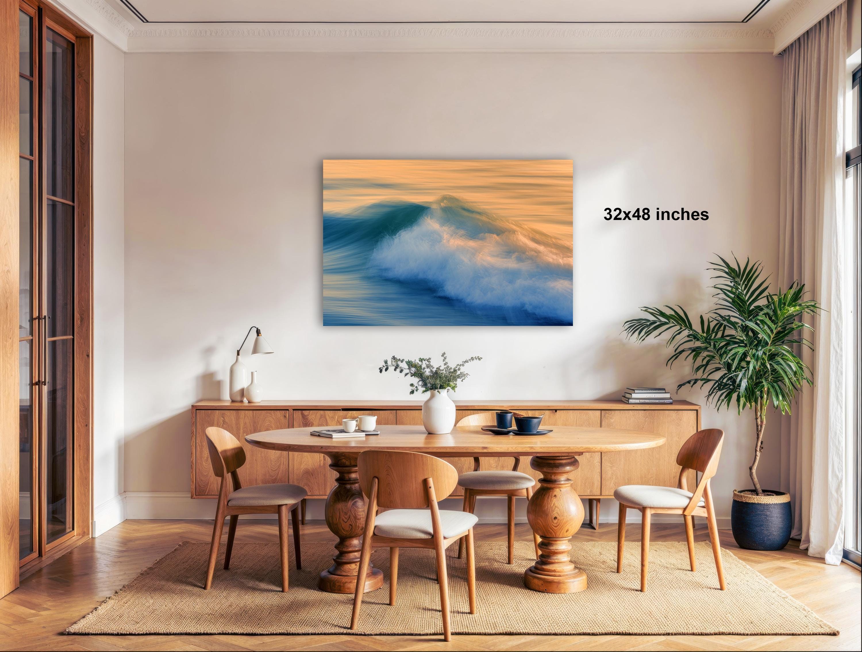 a modern dining room with a large wooden table surrounded by matching chairs. A large painting of a crashing wave hangs above the table, adding a dramatic element to the space. The room is decorated with various plants and other decorative items, creating a cozy and inviting atmosphere.