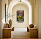 a serene and inviting hallway with a large painting of a vibrant autumn landscape hanging on the wall. The hallway features wooden benches and tables, as well as decorative elements such as vases and a potted plant, creating a warm and welcoming atmosphere.
