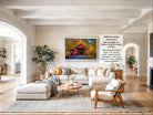 a large, comfortable living room with a cozy sectional sofa, a coffee table, and a fireplace. The room is decorated with various plants and has a rustic charm. The focal point of the room is a framed photograph of a red wooden bridge, which adds a pop of color to the space. The image also includes text that provides information about the frame size, material, and framing options.