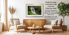 a serene indoor setting with a wooden coffee table, two white armchairs, and a potted plant. The room has a modern and minimalist design, with a large framed photograph of a waterfall hanging on the wall.