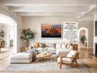 a large, modern living room with a comfortable sectional sofa, a coffee table, and a fireplace. The room is decorated with various plants and has a neutral color palette.