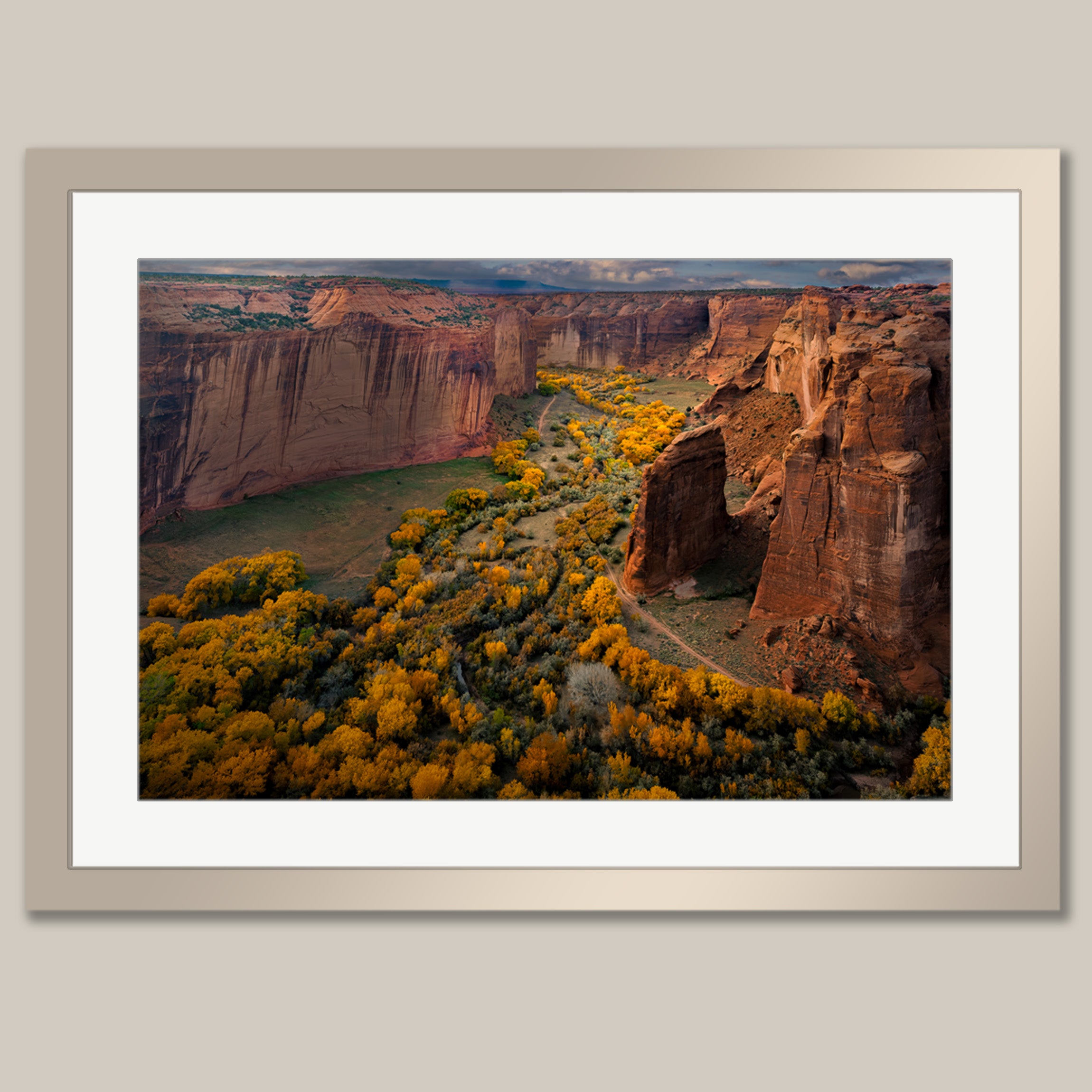 a breathtaking canyon landscape, with towering red rock formations and a vibrant display of fall foliage in the foreground.
