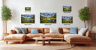 a living room with a large sectional sofa, a coffee table, and several framed landscape photographs displayed on the wall above the sofa.