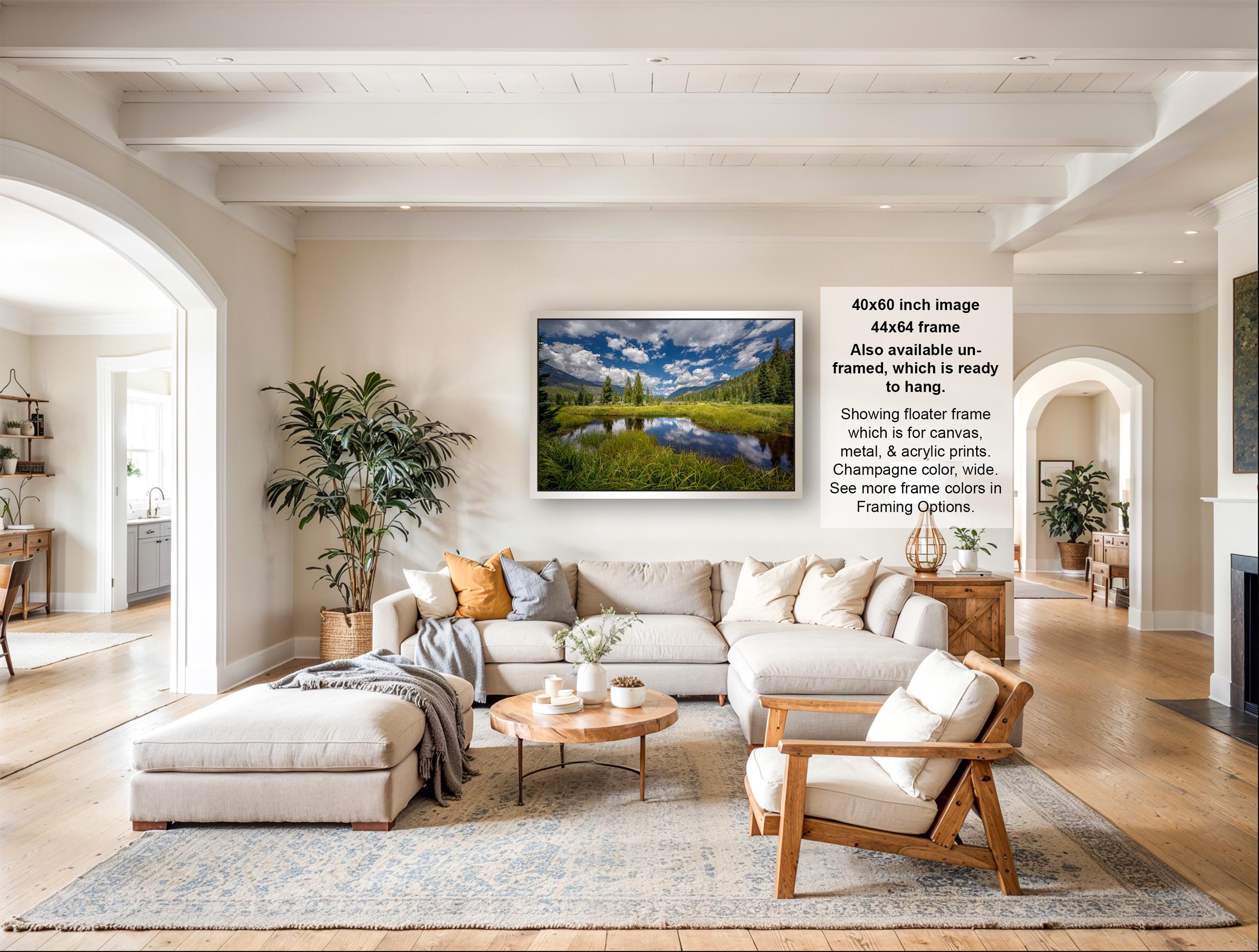 a spacious living room with a large sectional sofa, a coffee table, and a fireplace. The room is decorated with various plants and has a neutral color palette.