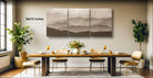 a modern dining room with a large wall-mounted painting depicting a mountain landscape. The dining table is set with wine glasses, plates, and a vase of flowers, creating a cozy and inviting atmosphere.