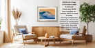 a living room with a wooden coffee table, two white armchairs, and a framed picture of a wave on the wall. The room has a modern and minimalist design, with a large window providing natural light.