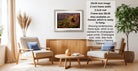 a living room with a framed landscape photograph hanging on the wall, a wooden coffee table in the center, and two chairs facing each other.