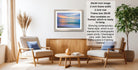 a living room with a framed landscape painting hanging on the wall, two chairs, a coffee table, and a potted plant.