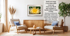 a living room with a framed photograph of a yellow flower on the wall, a wooden coffee table in the center, and two white armchairs facing each other.