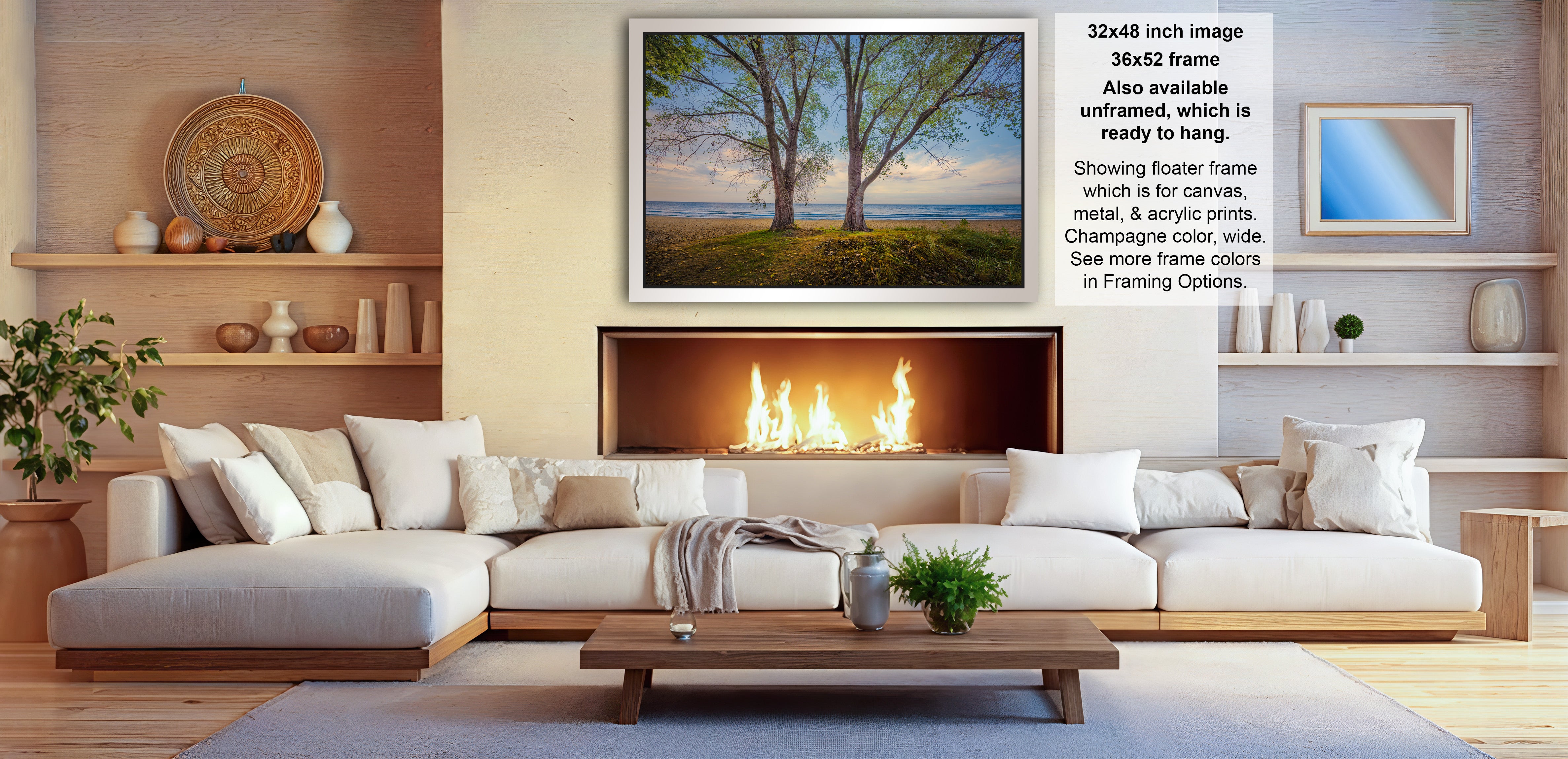 a cozy living room with a fireplace, white sofas, and a coffee table. The room has a warm and inviting atmosphere, with a fireplace providing a focal point and a painting hanging above it. The painting features a serene landscape with trees and a body of water, creating a peaceful and relaxing ambiance. The room is decorated with various items, including vases, a potted plant, and a bowl, adding to the overall aesthetic and comfort of the space.