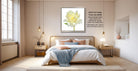 a serene and well-decorated bedroom with a large bed, wooden furniture, and a framed picture of a yellow flower on the wall.