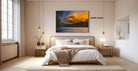 a serene bedroom with a large bed, wooden furniture, and a painting of a sunset over a lake hanging on the wall.