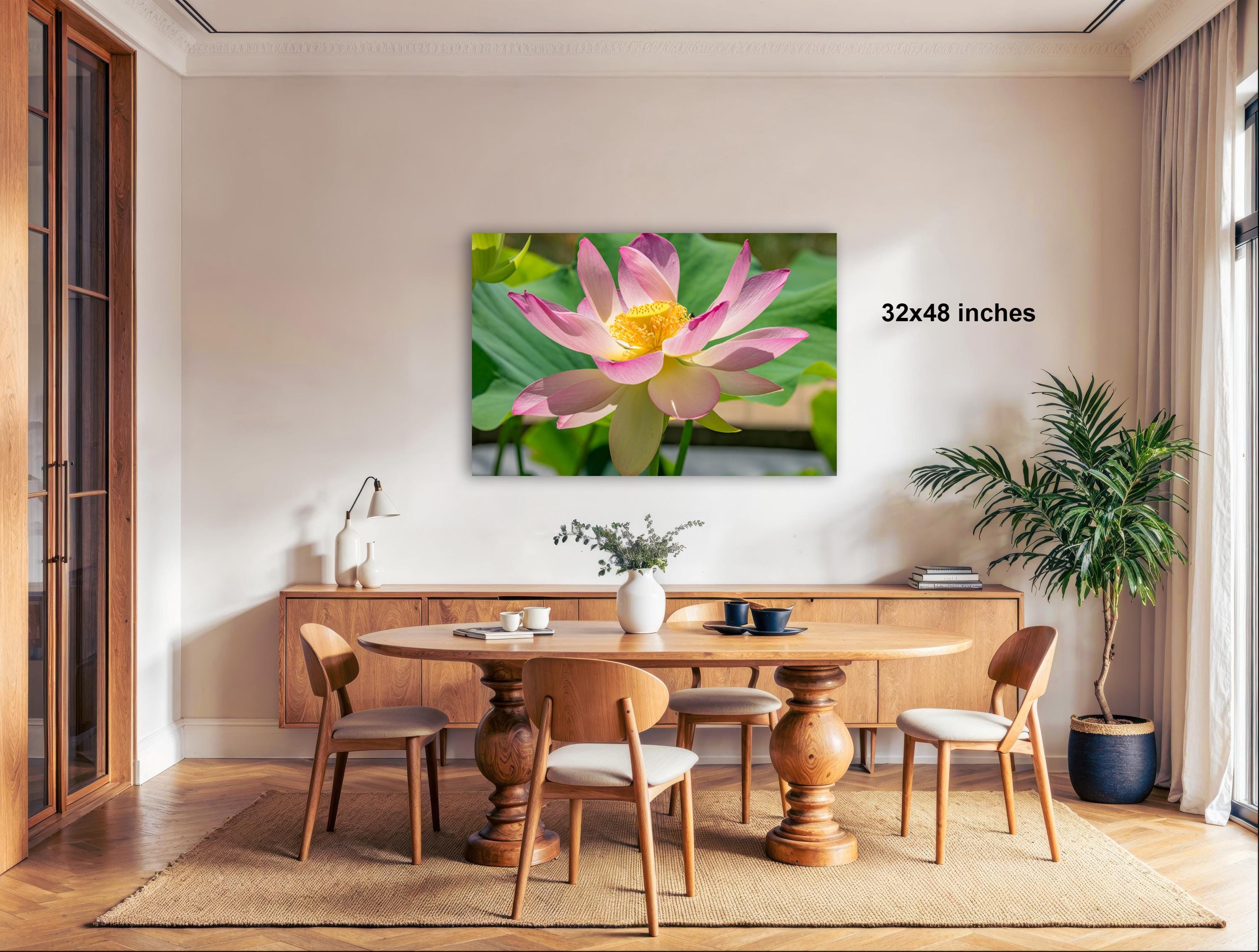 a large, vibrant, and colorful painting of a pink lotus flower hanging on a wall in a modern, well-lit room.