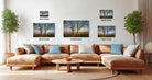 a living room with a large sectional sofa, a coffee table, and several potted plants. There are three framed landscape photographs displayed on the wall above the sofa, each with a different size and resolution.