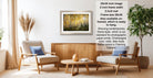 a living room with a framed picture of a forest on the wall, a wooden coffee table, two armchairs, and a potted plant.