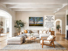 a spacious living room with a large sectional sofa, a coffee table, and a fireplace. The room is decorated with various plants and has a neutral color palette.