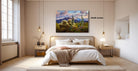 a serene bedroom with a large bed, wooden nightstands, and a painting of a desert landscape hanging on the wall.