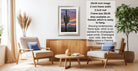 a living room with a framed desert landscape photograph hanging on the wall, a wooden coffee table in the center, and two chairs facing each other.