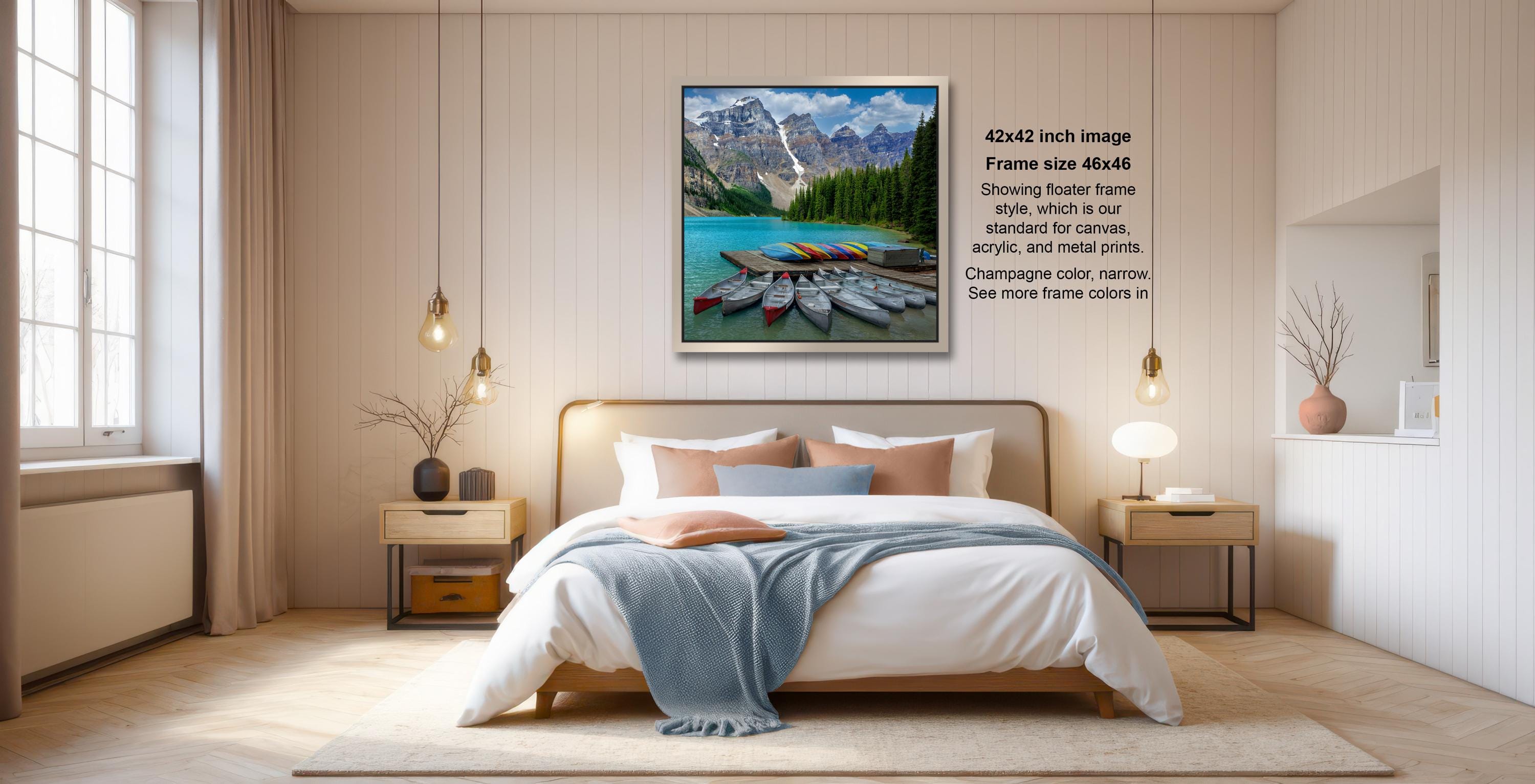 a serene bedroom scene with a large bed, wooden furniture, and a framed picture of a mountain landscape hanging on the wall.