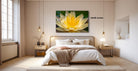 a serene bedroom with a large bed, a nightstand, and a large window. Above the bed, there is a framed picture of a yellow flower. The room has a minimalist and modern design, with white walls and a wooden floor.