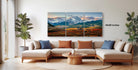 a large, multi-panel landscape painting hanging on a wall in a living room.