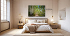 a serene bedroom with a large bed, wooden furniture, and a painting of a forest path on the wall.