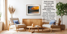 a living room with a framed landscape photograph hanging on the wall, a wooden coffee table in the center, and two chairs facing each other.