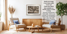 a living room with a framed photograph of a tree hanging on the wall, a wooden coffee table in the center, and two armchairs facing each other.