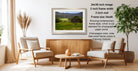 a serene living room with a wooden coffee table, two beige armchairs, and a framed landscape photograph hanging on the wall.