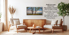 a living room with a wooden coffee table, two white armchairs, and a framed landscape painting hanging on the wall.