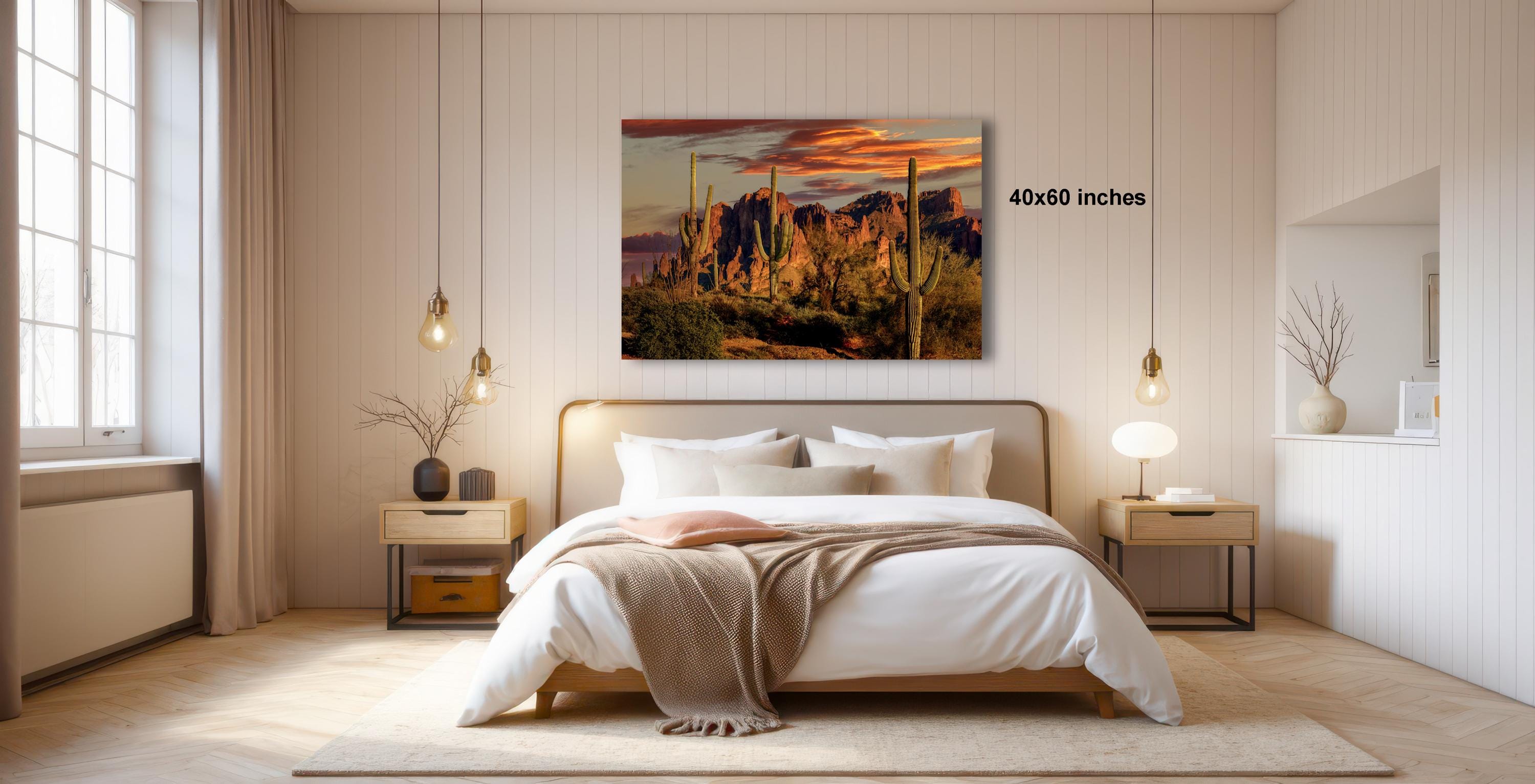 a serene bedroom with a large bed, wooden furniture, and a painting of a desert landscape hanging on the wall.