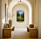 a serene and inviting hallway with a large painting of a lush green field and trees hanging on the wall. The painting is framed in a wooden frame and measures 32x48 inches. The hallway features wooden benches and tables, and there are decorative elements such as a vase and a bowl on display. The overall atmosphere of the hallway is calm and peaceful, with the natural landscape painting serving as a focal point.