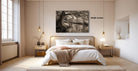 a serene bedroom with a large bed, wooden furniture, and a black and white photograph of a tree on the wall.