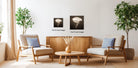a cozy living room with two comfortable armchairs, a wooden coffee table, and a vase of flowers. The room is decorated with potted plants and has a warm, inviting atmosphere.