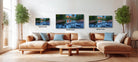 A cozy living room with a large sectional sofa, a coffee table, and three framed landscape paintings hanging on the wall.