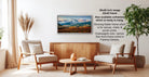 a living room with a wooden coffee table, two white armchairs, and a potted plant. A framed landscape painting is hanging on the wall, and there is text providing information about the frame options.