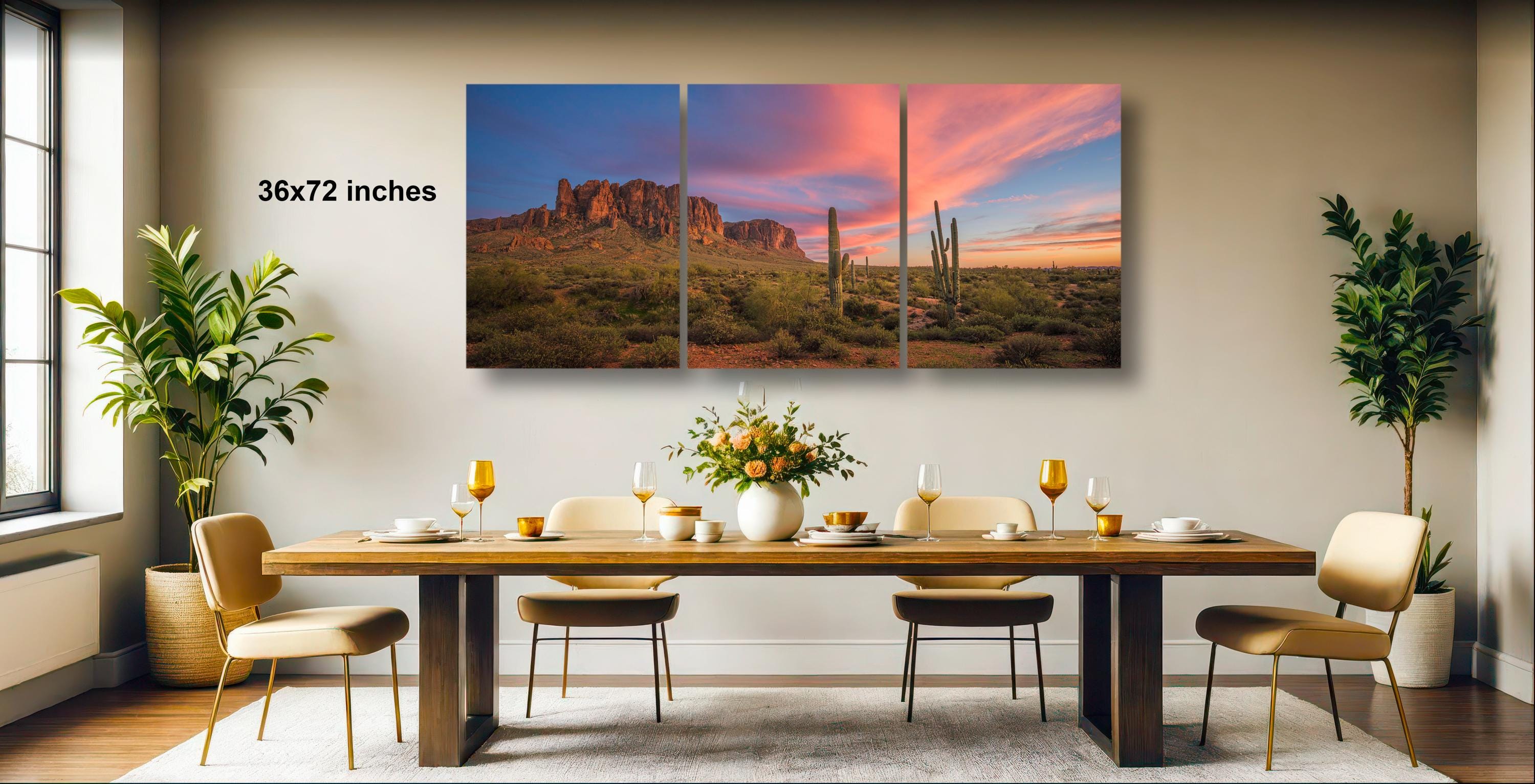 a modern dining room with a large, three-panel landscape painting of a desert scene hanging on the wall above a wooden dining table set with wine glasses, plates, and a vase of flowers.