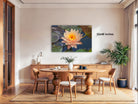 a large, vibrant painting of a water lily on a wall, with a dining table and chairs in the foreground.
