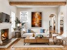 a cozy living room with a fireplace, a large framed abstract painting on the wall, a white sofa, a coffee table, and various decorative elements such as potted plants and vases.