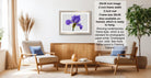 a living room with a framed purple flower on the wall, a wooden coffee table, two white armchairs, and a potted plant. The room has a modern and minimalist design, with a neutral color palette and clean lines.